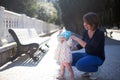 Mother and her small one year old daughter learning how to walk. Baby first steps Royalty Free Stock Photo