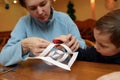 Mother and her son making paper snowflakes