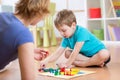 Mother and her son playing in board game Royalty Free Stock Photo