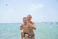 Mother and her son playing and running on the beach. Concept of friendly family Royalty Free Stock Photo