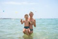 Mother and her son playing and running on the beach. Concept of friendly family Royalty Free Stock Photo