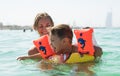 Mother and her son playing and running on the beach. Concept of friendly family Royalty Free Stock Photo