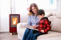 Mother With Her Son Read Book in a winter setting Royalty Free Stock Photo