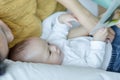 Mother and her son reading book in a bed before sleep. Familly story telling concept