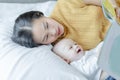 Mother and her son reading book in a bed before sleep. Familly story telling concept