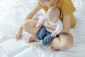 Mother and her son reading book in a bed before sleep. Familly story telling concept