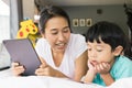 mother and her son using digital tablet in a bed at home. The use of concept of new generation  family  parenthood  authenticity Royalty Free Stock Photo