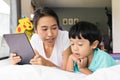 mother and her son using digital tablet in a bed at home. The use of concept of new generation  family  parenthood  authenticity Royalty Free Stock Photo