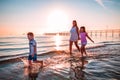 Mother with her sons playing on the shore Royalty Free Stock Photo