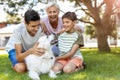 Mother and her sons playing with their dog Royalty Free Stock Photo