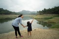Mother with her toddler in outdoor lake view