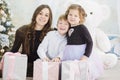 Mother and her two little children with Christmas gift boxes. Family on Christmas eve. Mother and little kids opening Xmas Royalty Free Stock Photo