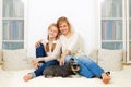 Mother with her 10 years old kid girl sitting home, casual lifestyle photo series. Royalty Free Stock Photo