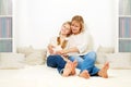 Mother with her 10 years old kid girl sitting home, Royalty Free Stock Photo