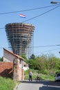 Mother and her young child playing in Water tower, with bullet and missile holes from the 1991-1995 conflict