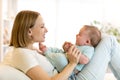 Mother and baby son smiling and playing