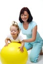 Mother hold daughter on Fitness Ball