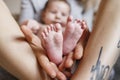 Mother hold feets of newborn baby. Cute photo of baby boy. Childhood concept Royalty Free Stock Photo