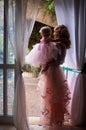 Mother hold her daughter near window Royalty Free Stock Photo