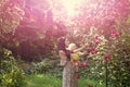 Mother hold son at blossoming roses on idyllic sunny day