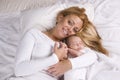 Mother holding baby boy asleep in her arms Royalty Free Stock Photo