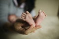 Mother holding baby feet in hand Royalty Free Stock Photo