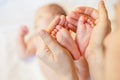 Mother holding baby feet at hands Royalty Free Stock Photo