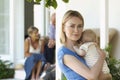 Mother Holding Baby On Porch With Grandparents Behind Royalty Free Stock Photo