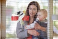 Mother, holding and baby for show of bird, zoo or cage on farm for bonding, relationship or childhood. Woman, infant and