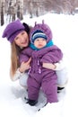 Mother holding a baby, snow, winter park, walk Royalty Free Stock Photo