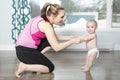 Mother holding a baby under his arms in living room Royalty Free Stock Photo