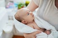 Mother holding baby wrapped in towel after bath Royalty Free Stock Photo