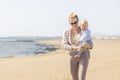 Mother holding and carrying his infant baby boy son on sandy beach enjoying summer vacationson on Lanzarote island Royalty Free Stock Photo