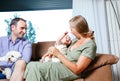 Mother holding cheerful baby while father is looking at them proud Royalty Free Stock Photo
