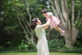 Mother holding cute baby in the garden