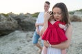 Young parents with cute baby girl outdoors on the beach Royalty Free Stock Photo