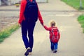 Mother holding hand of little daughter with Royalty Free Stock Photo