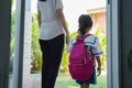 Mother holding hand of little daughter with backpack Royalty Free Stock Photo