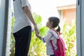 Mother holding hand of little daughter with backpack Royalty Free Stock Photo