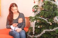 Mother holding hand of newborn baby boy by Christmas tree Royalty Free Stock Photo