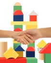 Mother holding hand of son, toy tower background Royalty Free Stock Photo