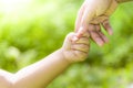 Mother is holding hands with boy boy in the wild.Hand in hand walking forward.