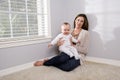 Mother holding happy six month old baby