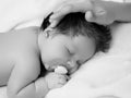 Mother holding head of baby In the safe hands. Mother& x27;s Care. Mom& x27;s Hand Stroking Sleeping Baby& x27;s Royalty Free Stock Photo