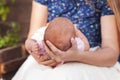 Mother holding head of her newborn son in hands. The baby on hands at mum. Loving mother hand holding cute sleeping newborn baby Royalty Free Stock Photo