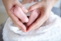 Purest love. A mother holding her baby girls tiny feet in her hands so that it forms a heart. Royalty Free Stock Photo