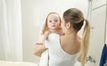 Mother holding her baby in towel at bathroom Royalty Free Stock Photo