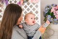 Mother holding her child. Mom playing with laughing kid. Family at home Royalty Free Stock Photo