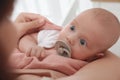 Mother holding her cute little baby with pacifier at home Royalty Free Stock Photo