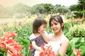 Mother holding her daughter in garden Royalty Free Stock Photo